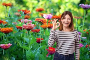 fiori e donna con segno ok con la mano