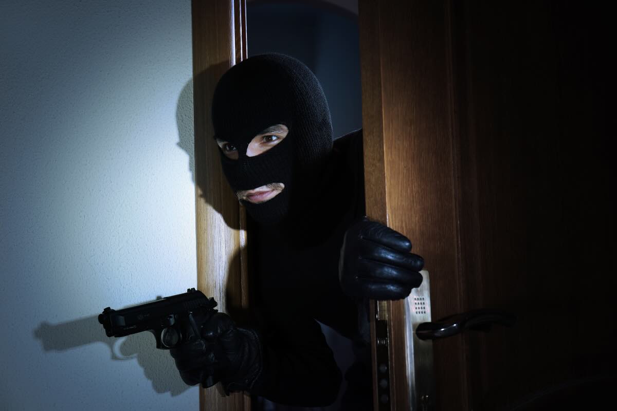 ladro con passamontagna e pistola