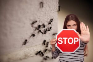 donna con segnale stop e formiche