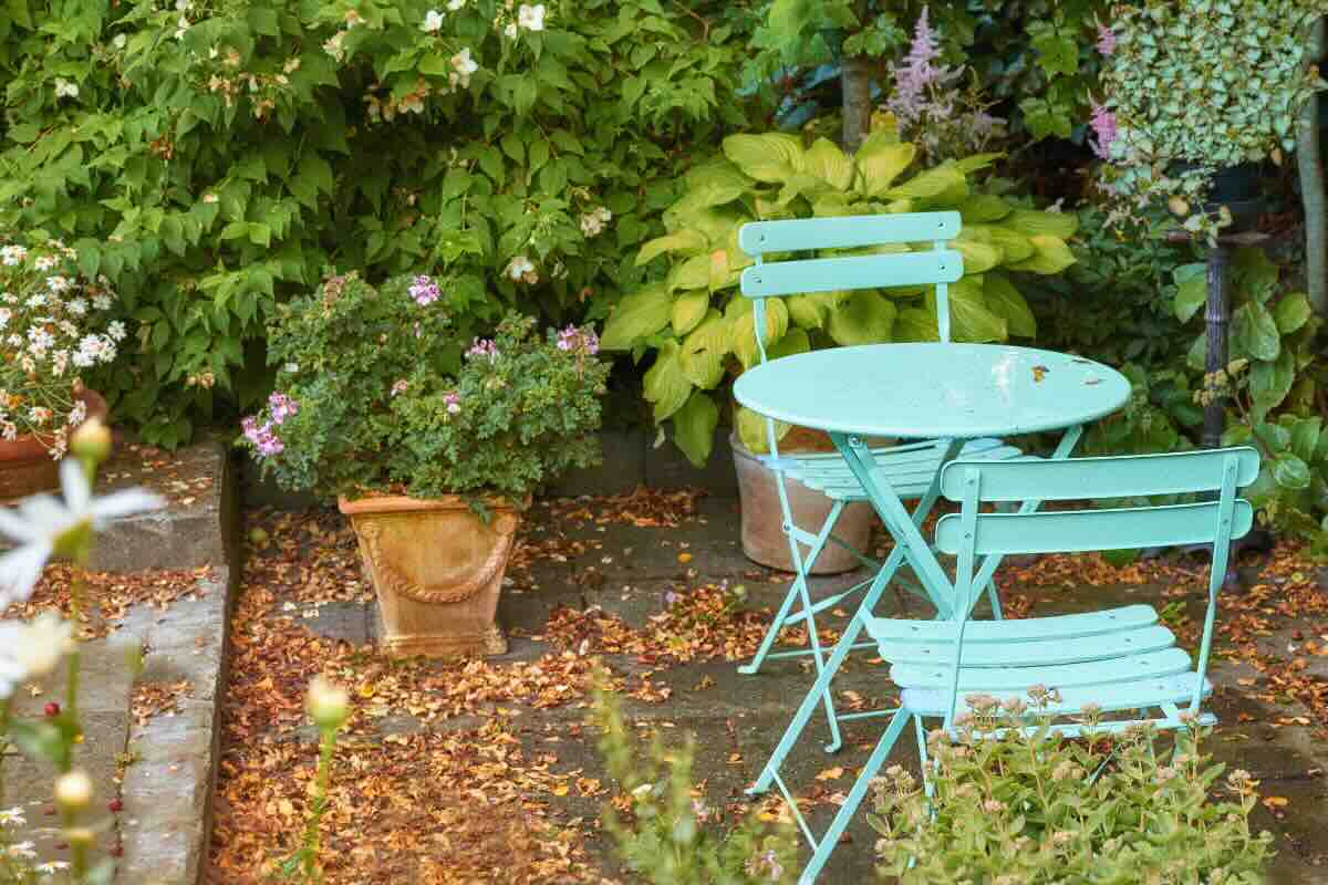 giardino con foglie e tavolo e sedie 